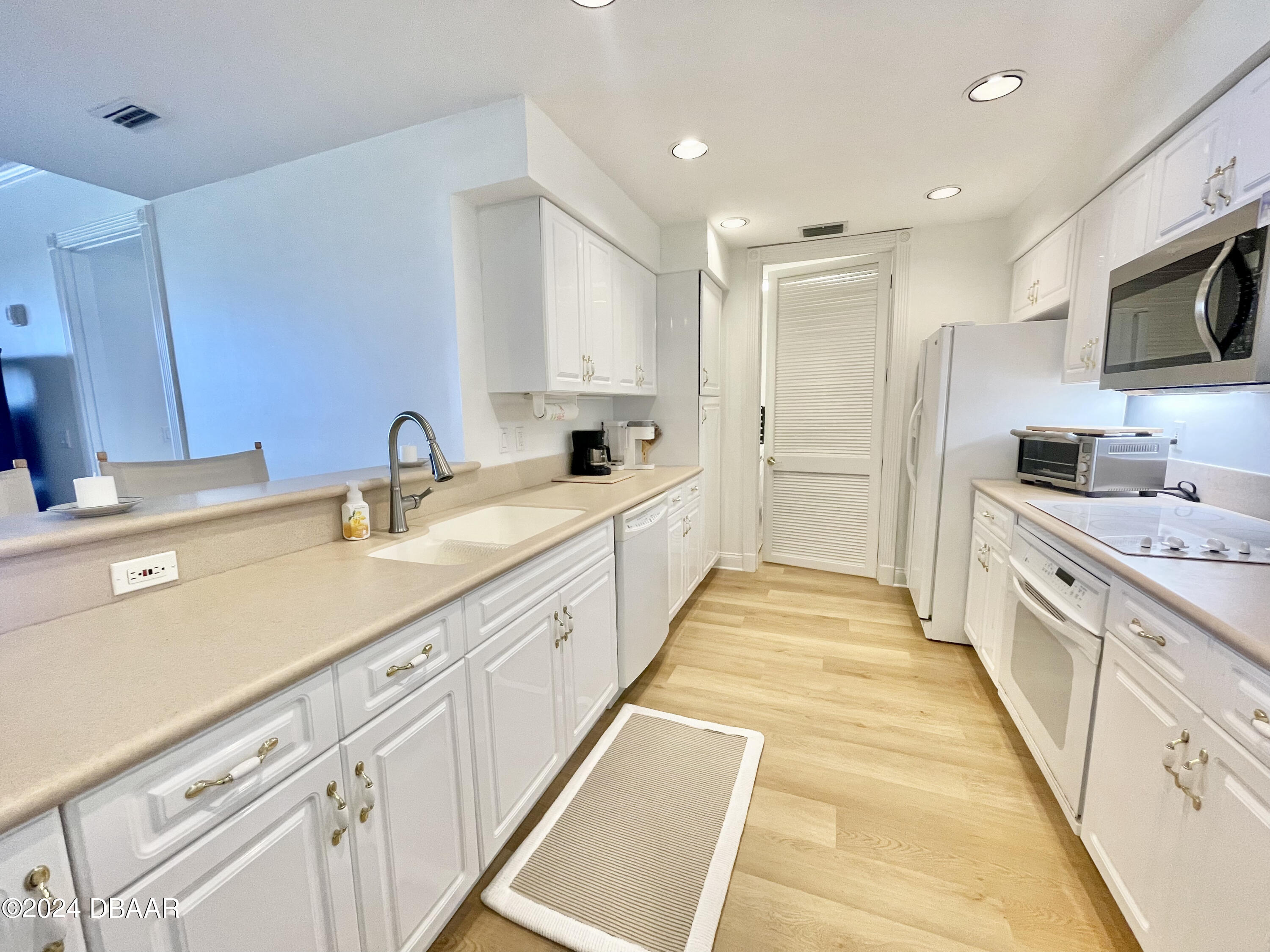 4626 Harbour Village Boulevard, Unit 3505 Ponce Inlet, FL 32127 - Photo 5 of 38 a large white kitchen with stainless steel appliances granite countertop lots of counter top space and cabinets