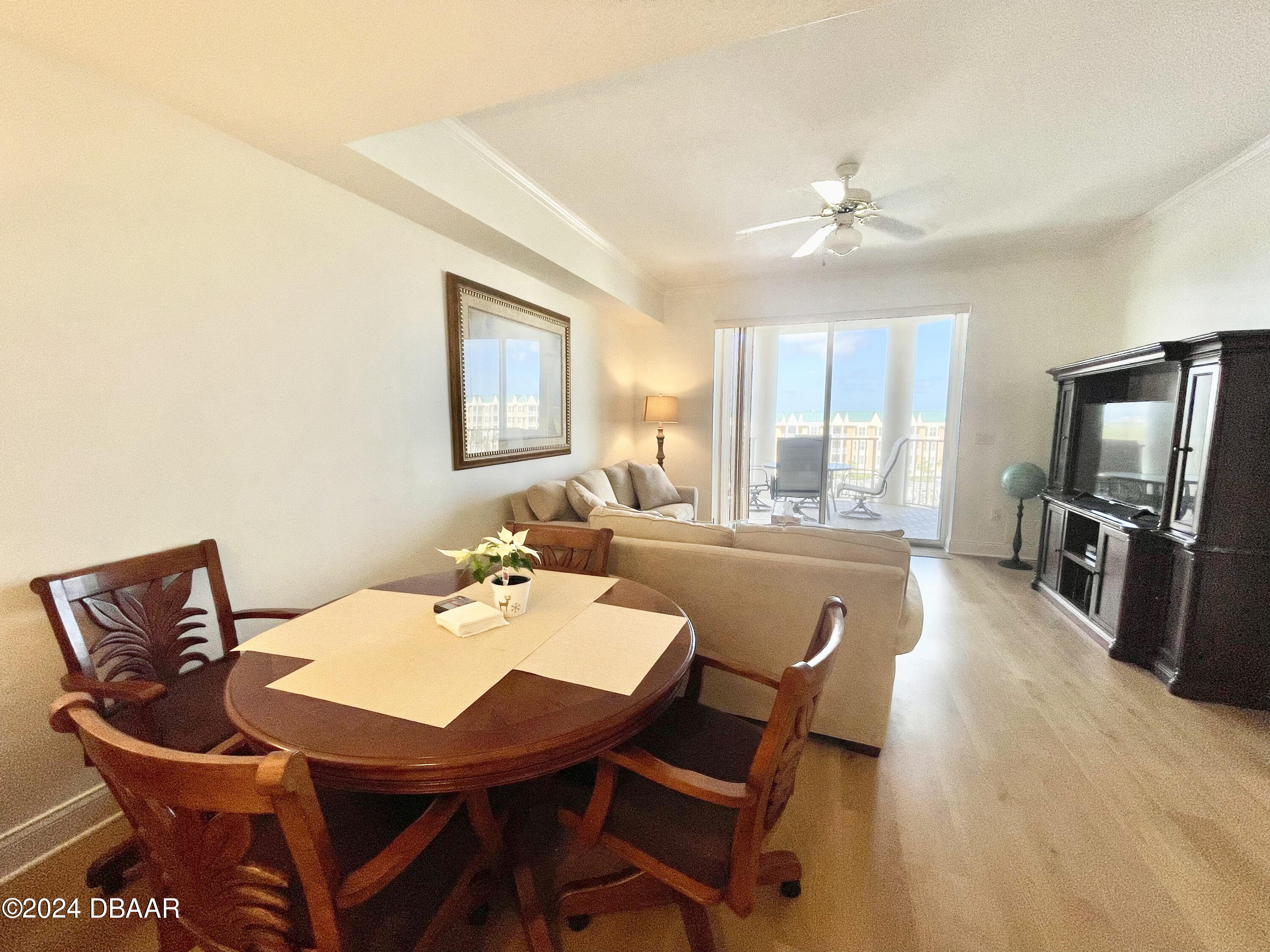 4626 Harbour Village Boulevard, Unit 3505 Ponce Inlet, FL 32127 - Photo 10 of 38 a view of a dining room with furniture window and wooden floor