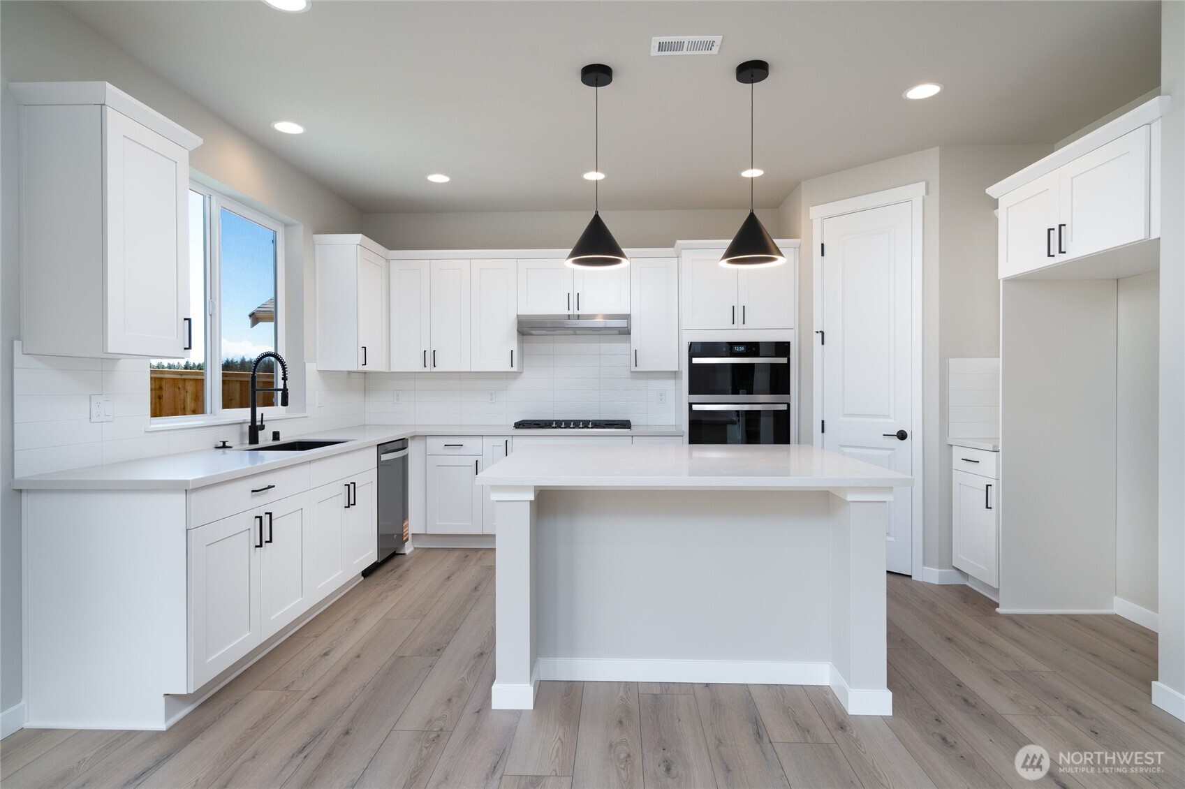 2421 Ridgeway Drive Oak Harbor, WA 98277 - Photo 5 of 12 a kitchen with kitchen island a white counter top space stainless steel appliances and cabinets