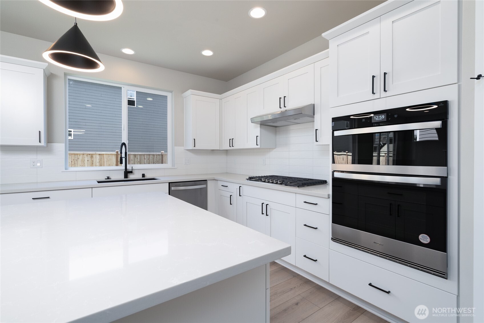 2421 Ridgeway Drive Oak Harbor, WA 98277 - Photo 6 of 12 a kitchen with stainless steel appliances a stove a microwave and white cabinets