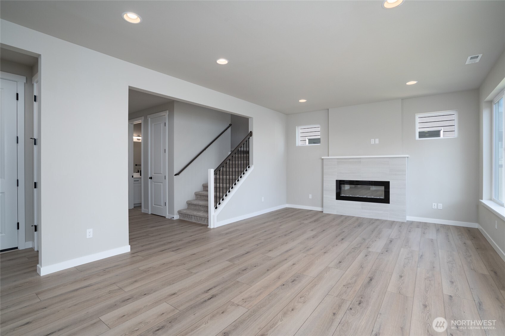 2421 Ridgeway Drive Oak Harbor, WA 98277 - Photo 7 of 12 an empty room with wooden floor and staircase