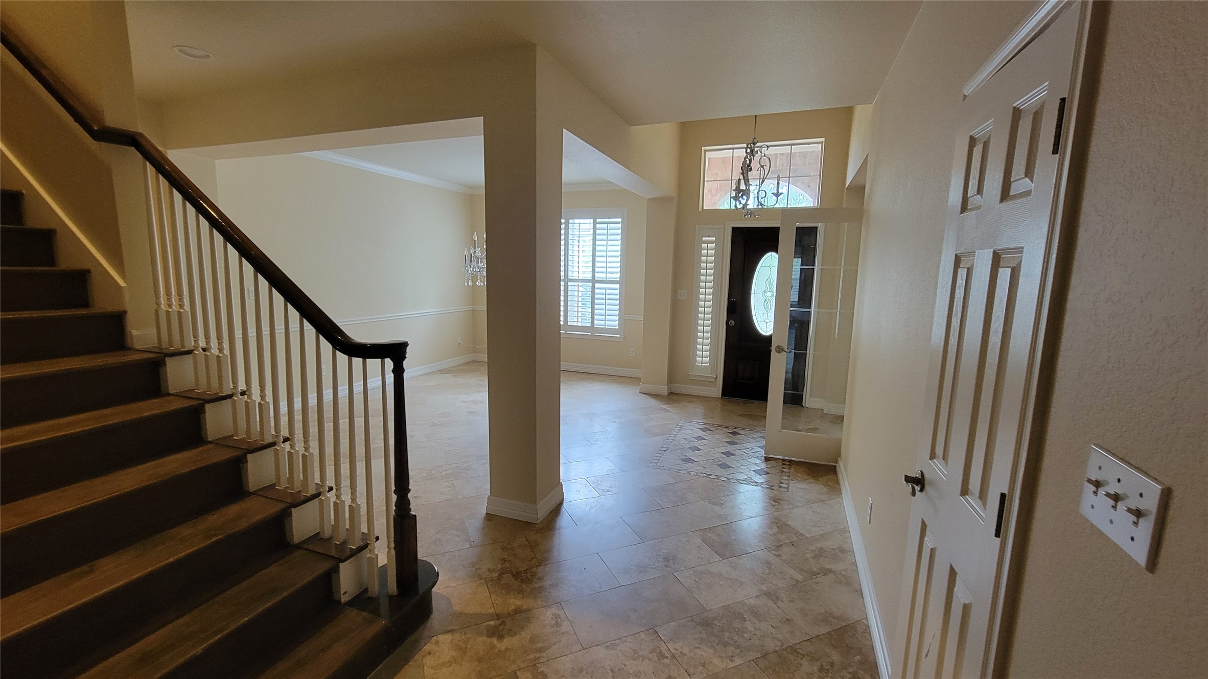 2832 Grimes Ranch Road Austin, TX 78732 - Photo 5 of 37 Enter into a welcoming foyer with a grand staircase and polished tile flooring, leading to inviting living spaces.
