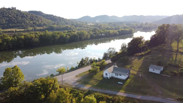 an aerial view of residential house with outdoor space and river