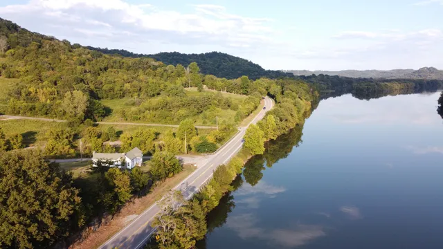a front view of a house with a garden and yard