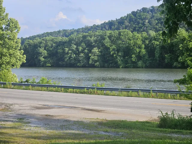 a view of a green field with an ocean view