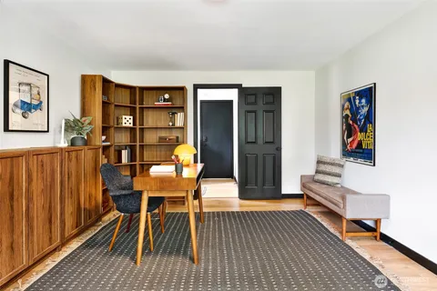a workspace with furniture window and wooden floor