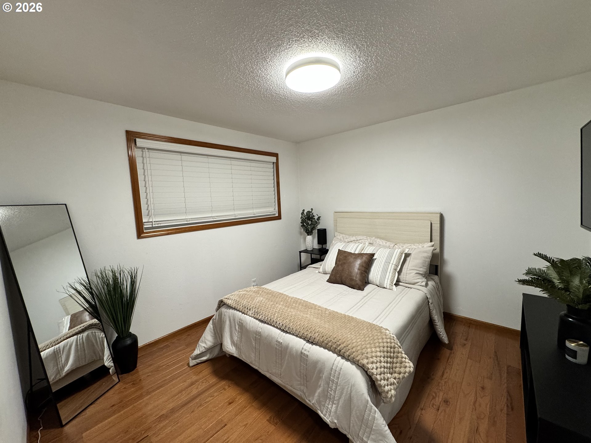 1091 Longridge Drive Springfield, OR 97478 - Photo 10 of 21 a bedroom with a bed and a flat tv screen on a dresser