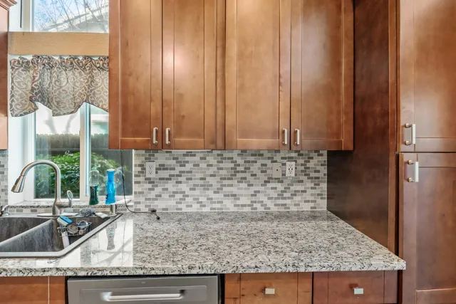 a living room with a bed furniture and a large window