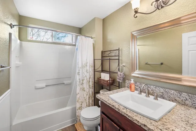 a bedroom with a large bed and a window