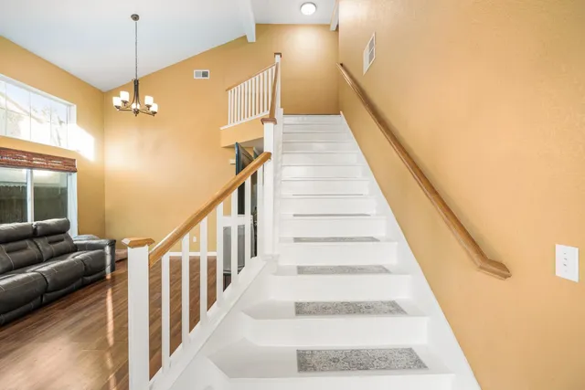 a kitchen with stainless steel appliances granite countertop a refrigerator stove and sink