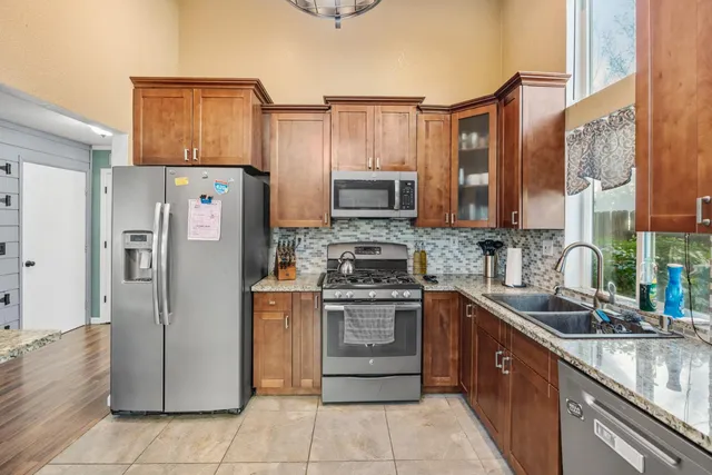a view of a walk in closet with wooden floor