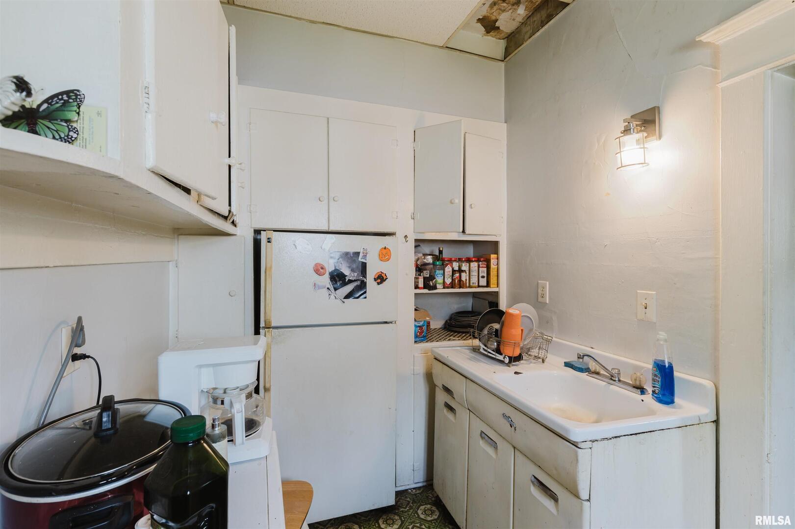 209 North Springer Street Carbondale, IL 62901 - Photo 28 of 30 a white kitchen with a sink a stove and a refrigerator