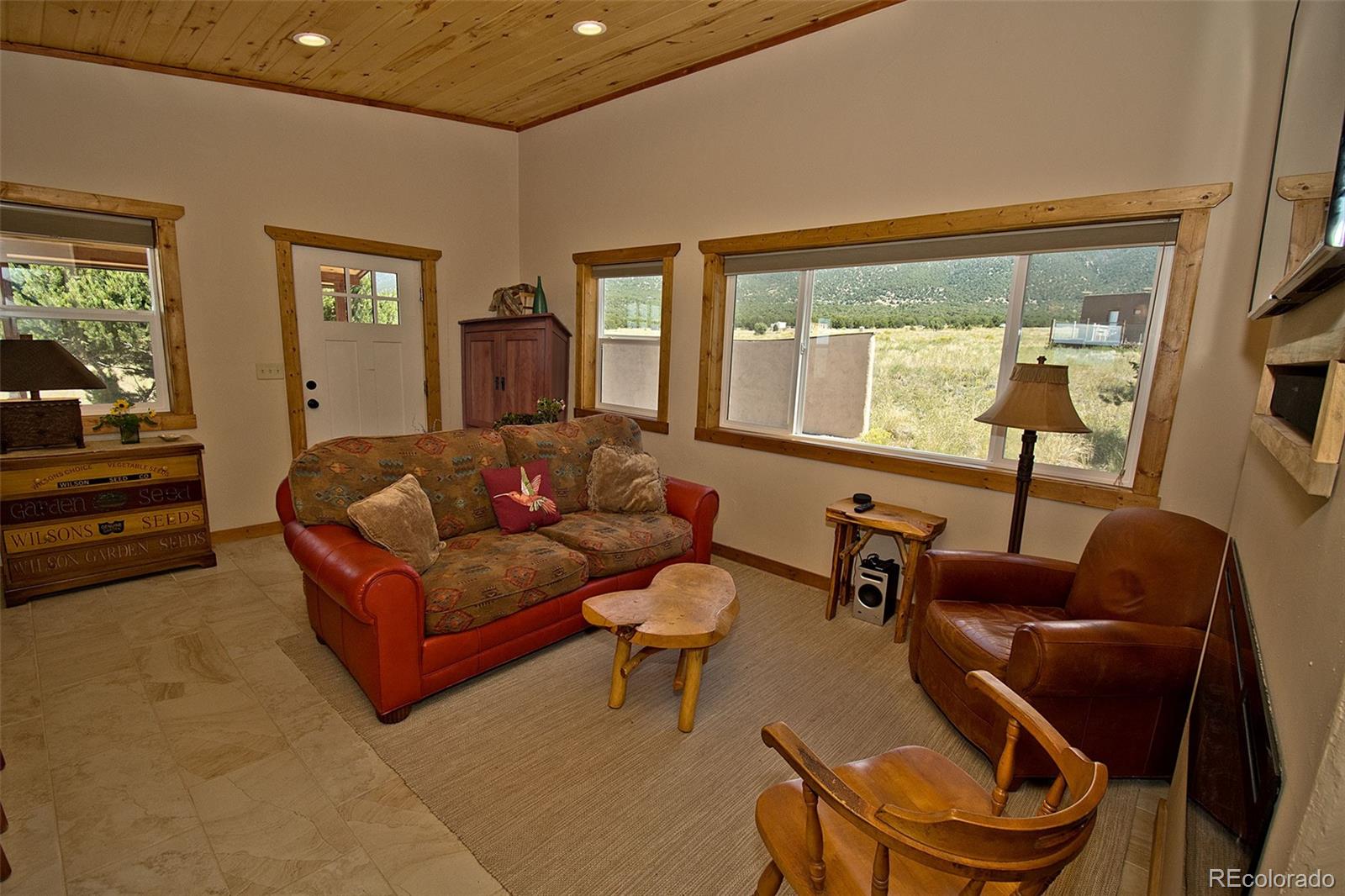 3421 Camino Del Rey Crestone, CO 81131 - Photo 11 of 41 a living room with furniture and a large window
