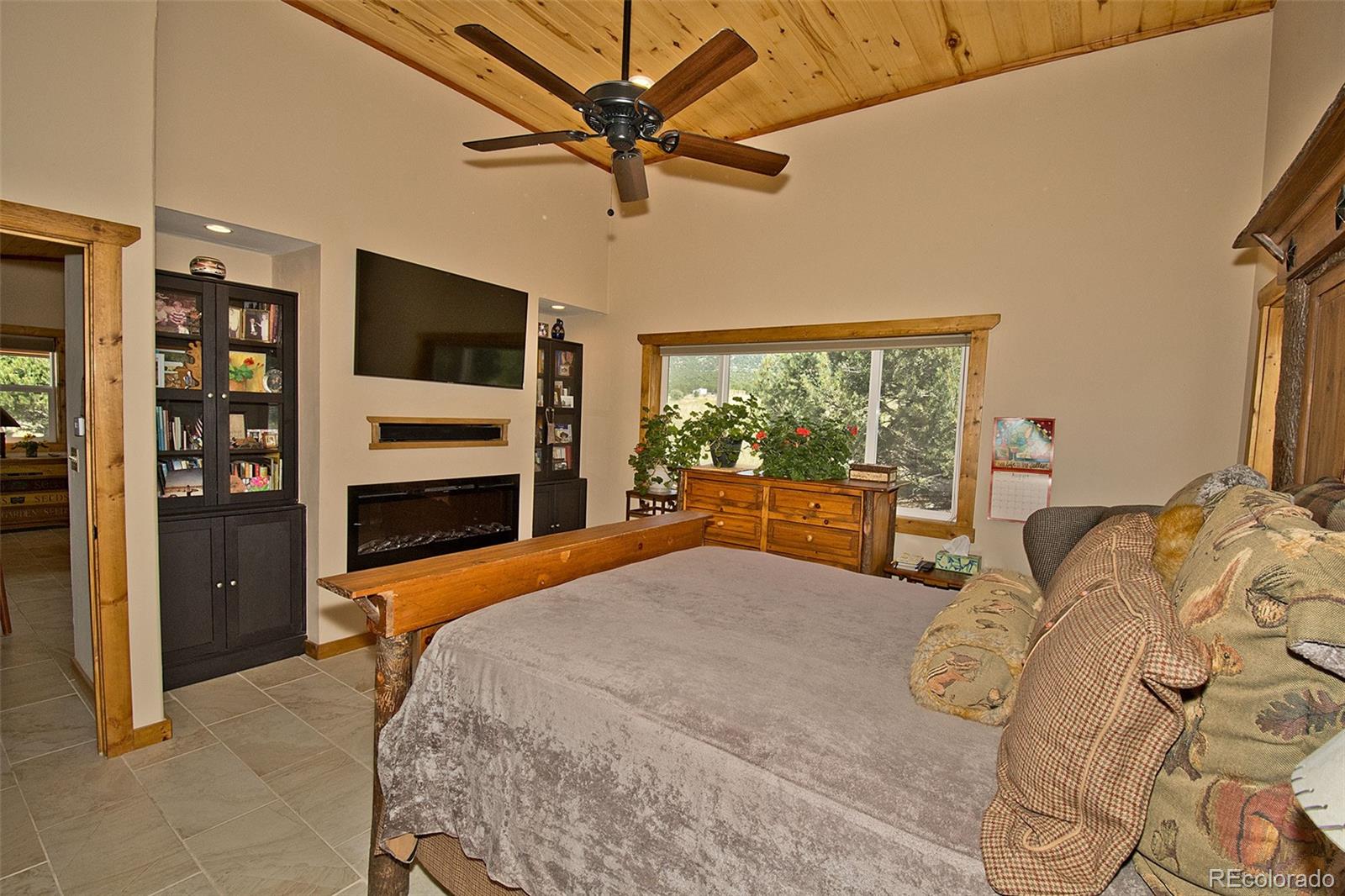 3421 Camino Del Rey Crestone, CO 81131 - Photo 22 of 41 a bedroom with a large bed and a flat tv screen