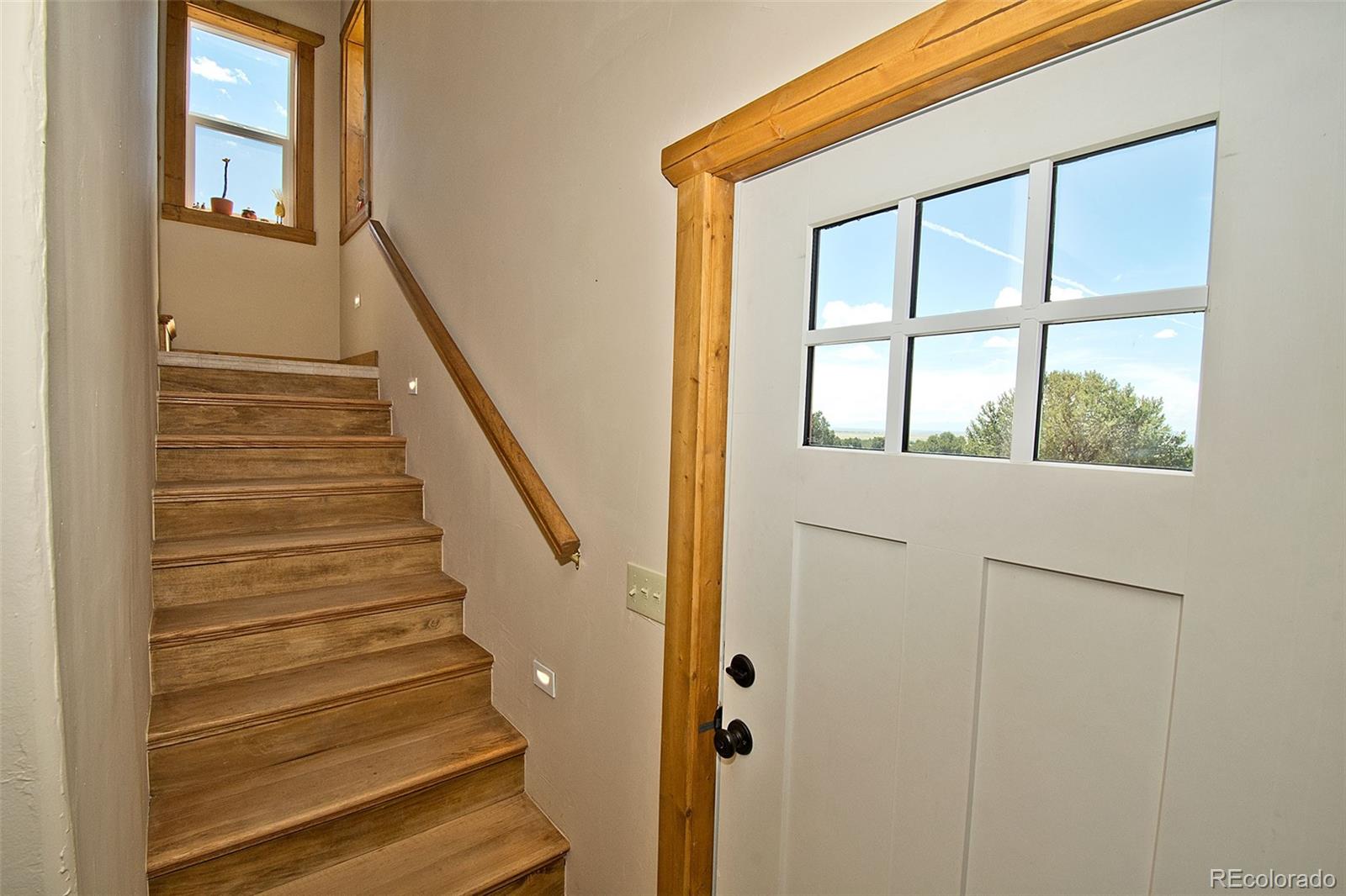 3421 Camino Del Rey Crestone, CO 81131 - Photo 28 of 41 a view of staircase with wooden floor and front door
