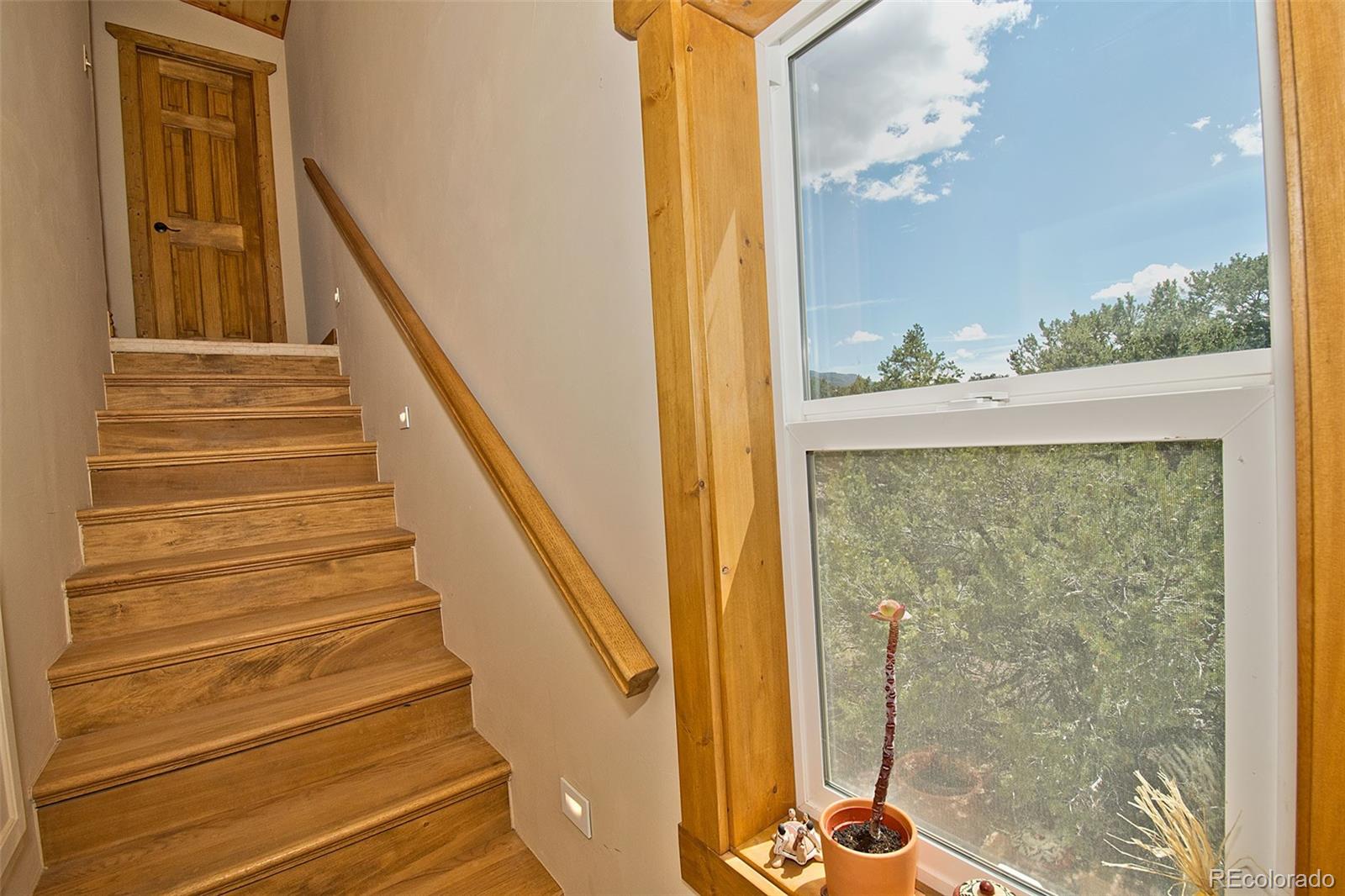 3421 Camino Del Rey Crestone, CO 81131 - Photo 29 of 41 a view of a room with wooden floor and windows