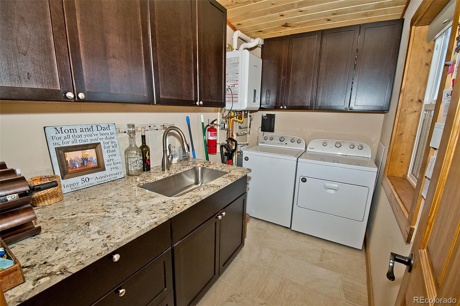 3421 Camino Del Rey Crestone, CO 81131 - Photo 38 of 41 a kitchen with granite countertop cabinets sink and washing machine