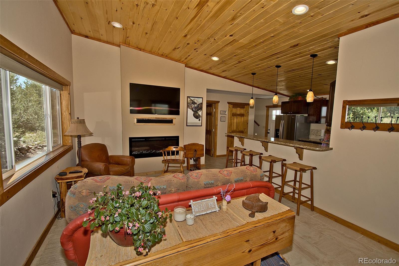 3421 Camino Del Rey Crestone, CO 81131 - Photo 9 of 41 a living room with furniture and a flat screen tv