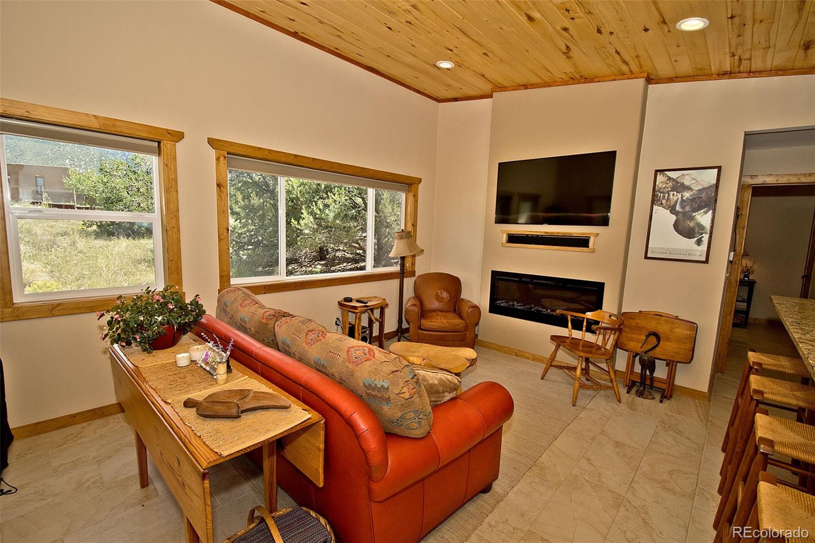 3421 Camino Del Rey Crestone, CO 81131 - Photo 10 of 41 a living room with furniture a flat screen tv and floor to ceiling window