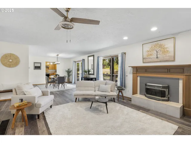 a living room with furniture a window and a fireplace