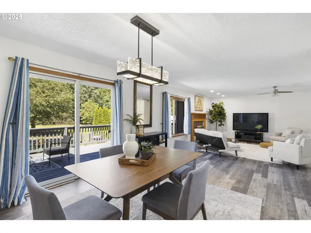 a living room with furniture a flat screen tv and a large window