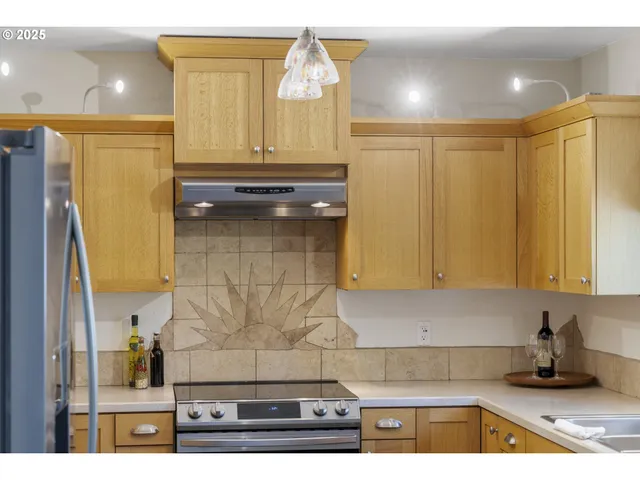 a kitchen with a refrigerator a stove and cabinets
