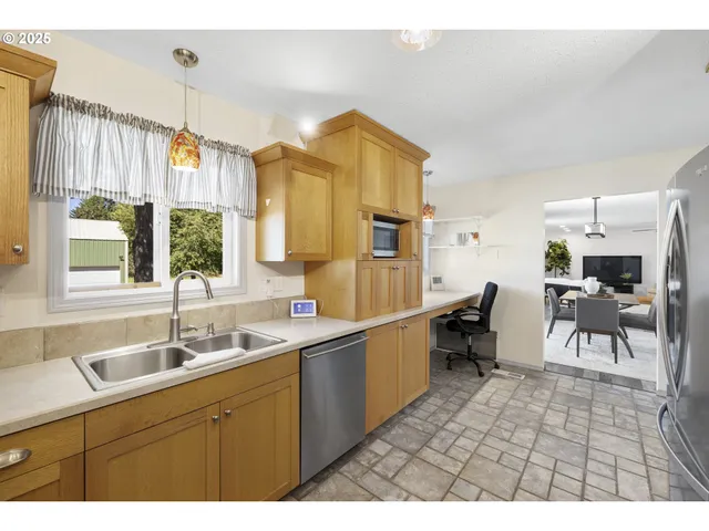 a kitchen with a sink cabinets and window
