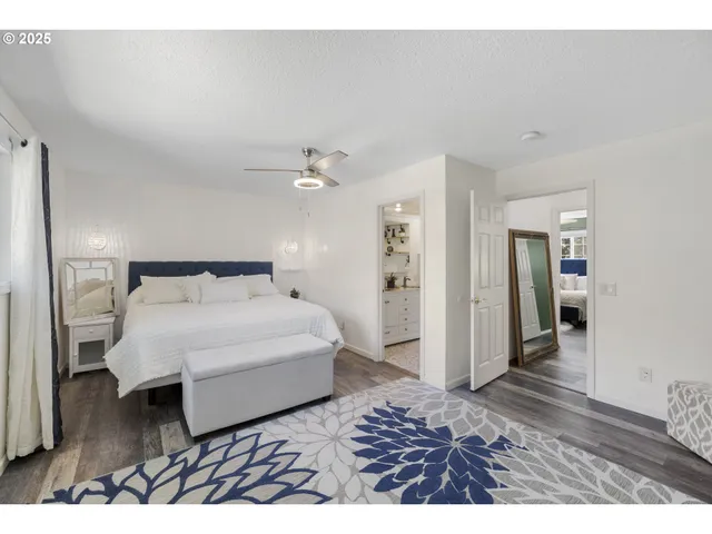 a spacious bedroom with a bed and a mirror