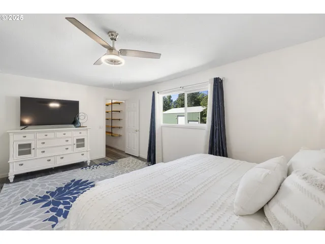 a bedroom with a bed and a flat screen tv