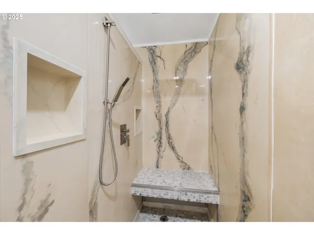 a picture of a bathroom with a shower