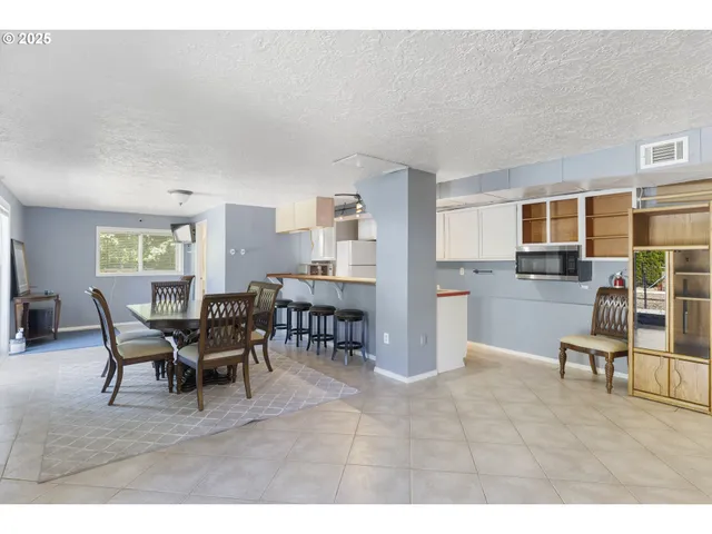 a living room with furniture a dining table and a wooden floor