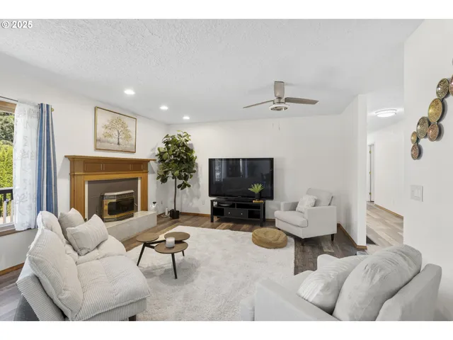 a living room with furniture a fireplace and a flat screen tv
