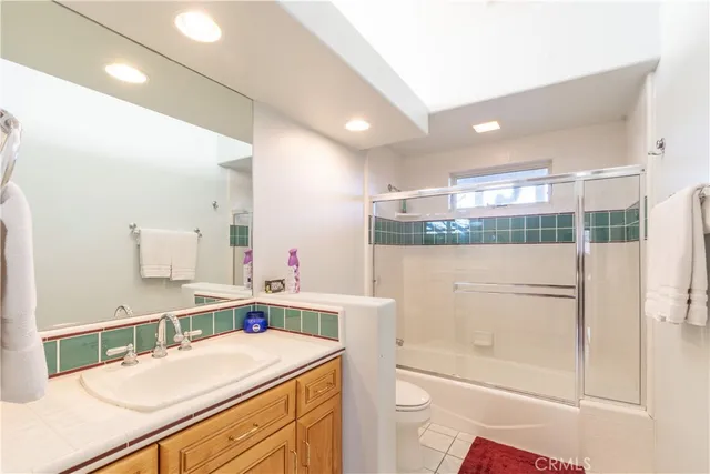 a bedroom with a bed and glass window