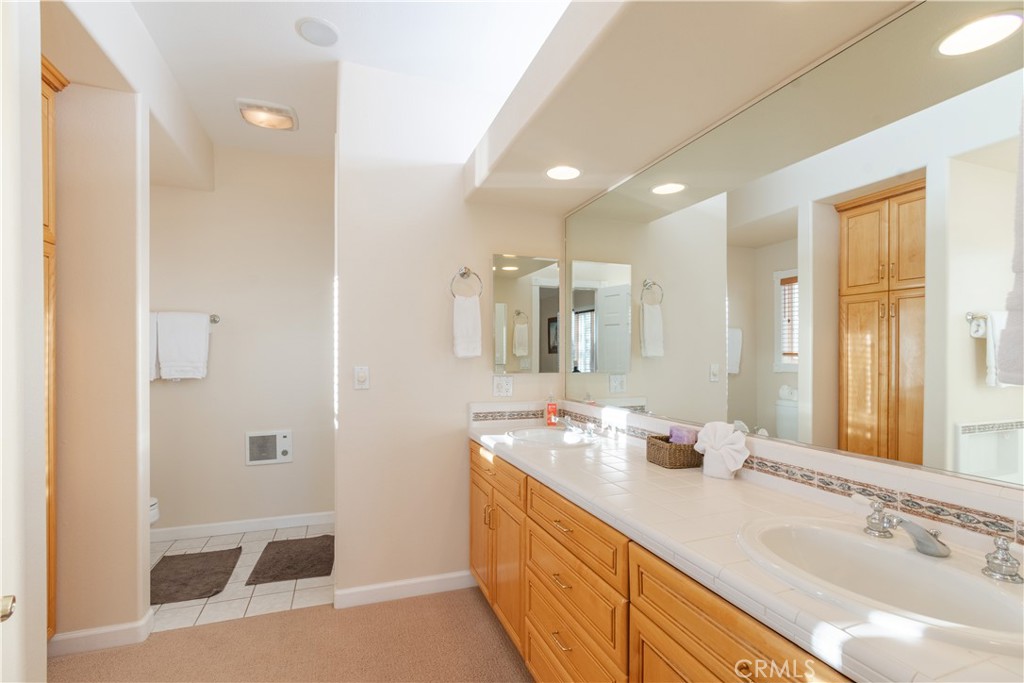 390 San Marcos Road Paso Robles, CA 93446 - Photo 14 of 62 a bathroom with a double vanity sink mirror and double