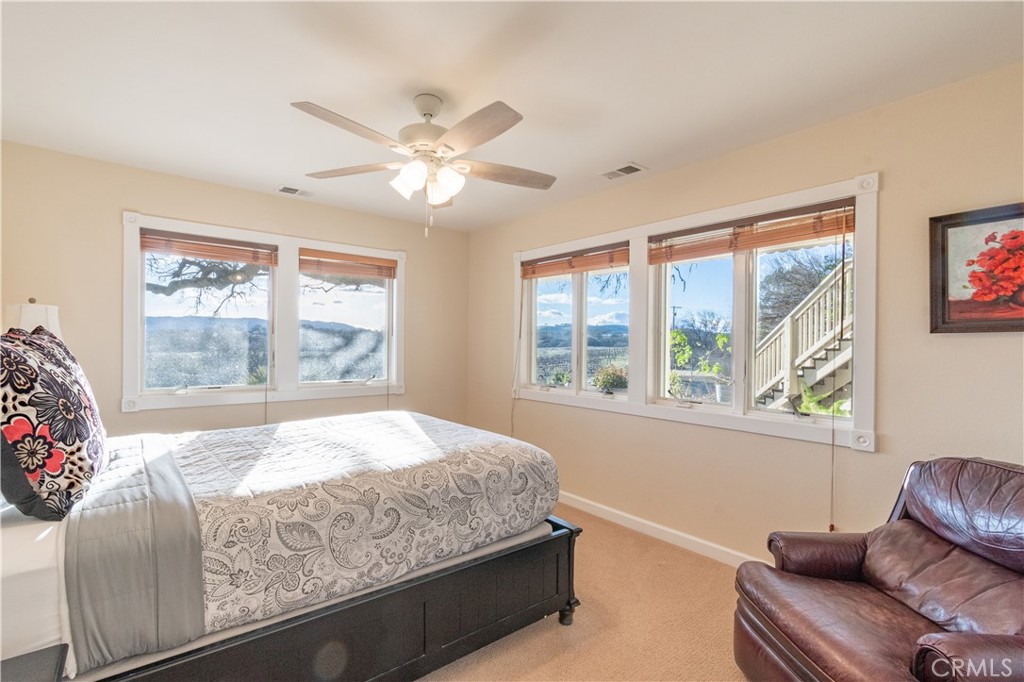 390 San Marcos Road Paso Robles, CA 93446 - Photo 17 of 62 a bedroom with a large bed and a window