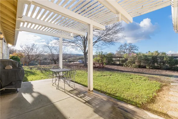 a large kitchen with stainless steel appliances granite countertop a refrigerator a sink dishwasher a dining table and chairs with wooden floor