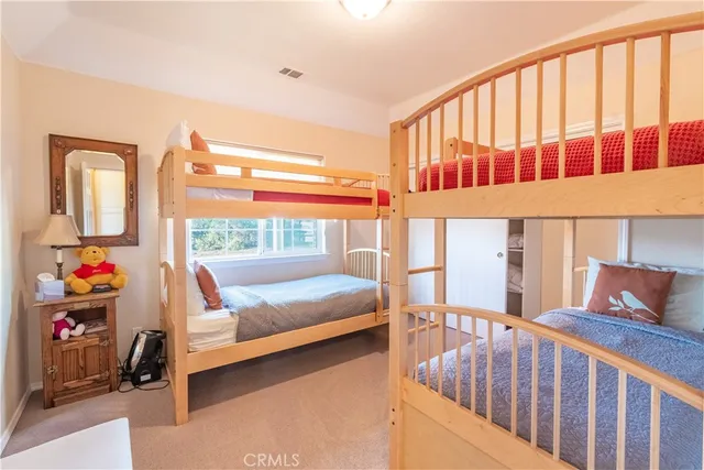 a bathroom with a double vanity sink and mirror with toilet