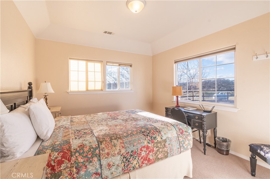 390 San Marcos Road Paso Robles, CA 93446 - Photo 43 of 62 a bedroom with a bed and a table in it next to a window