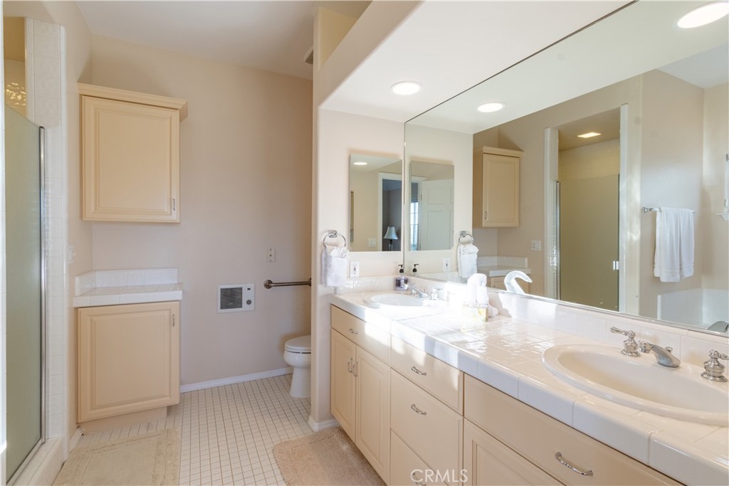 390 San Marcos Road Paso Robles, CA 93446 - Photo 46 of 62 a bathroom with a double vanity sink and mirror with toilet