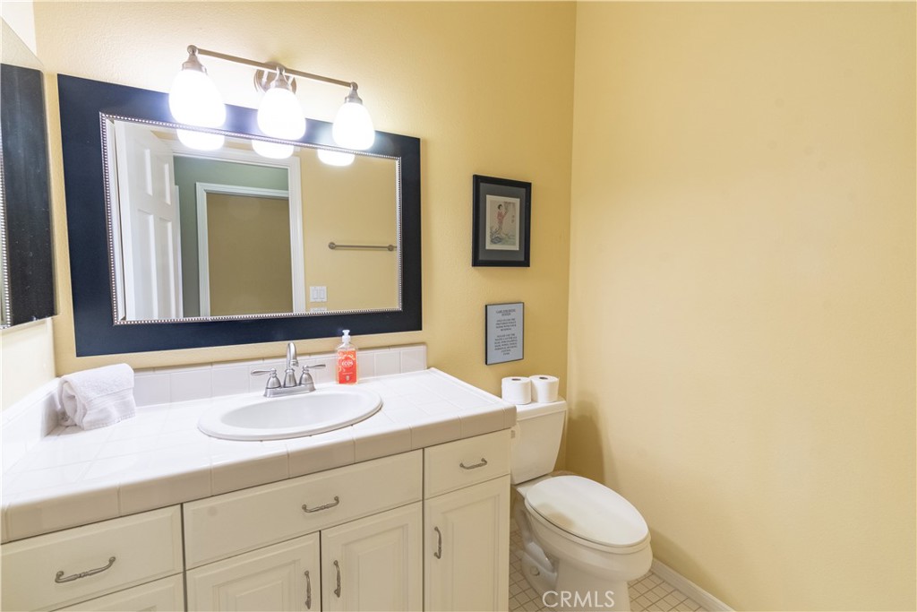 390 San Marcos Road Paso Robles, CA 93446 - Photo 48 of 62 a bathroom with a toilet sink and mirror