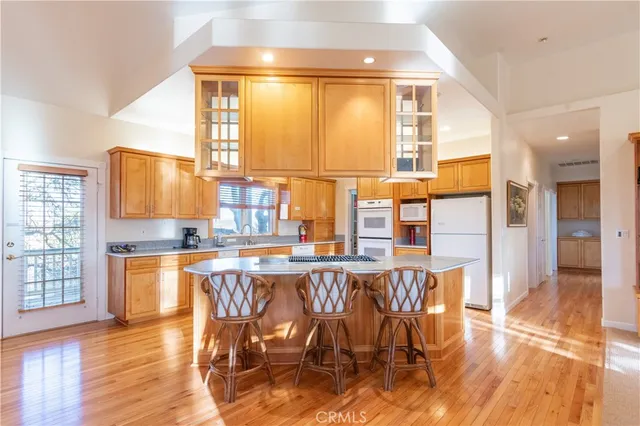 a kitchen with stainless steel appliances granite countertop a sink stove and cabinets