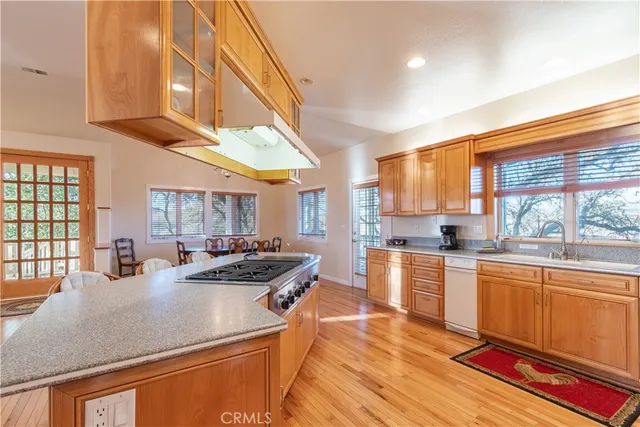 a living room with furniture a flat screen tv and a chandelier