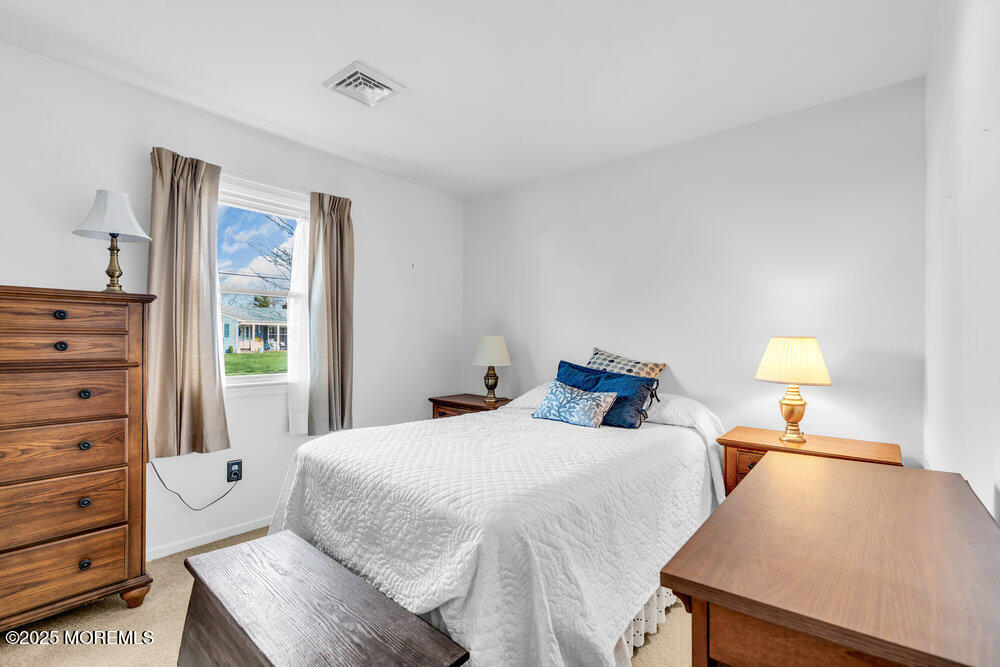 9 Scheiber Drive Brick, NJ 08723 - Photo 17 of 53 a bedroom with a bed and a lamp on dresser