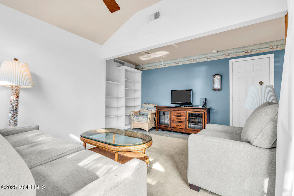 9 Scheiber Drive Brick, NJ 08723 - Photo 37 of 53 a living room with furniture and a flat screen tv