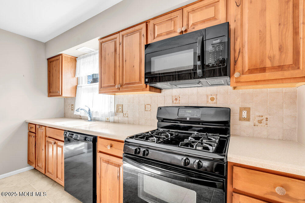 9 Scheiber Drive Brick, NJ 08723 - Photo 8 of 53 a kitchen with stainless steel appliances a sink a stove and cabinets