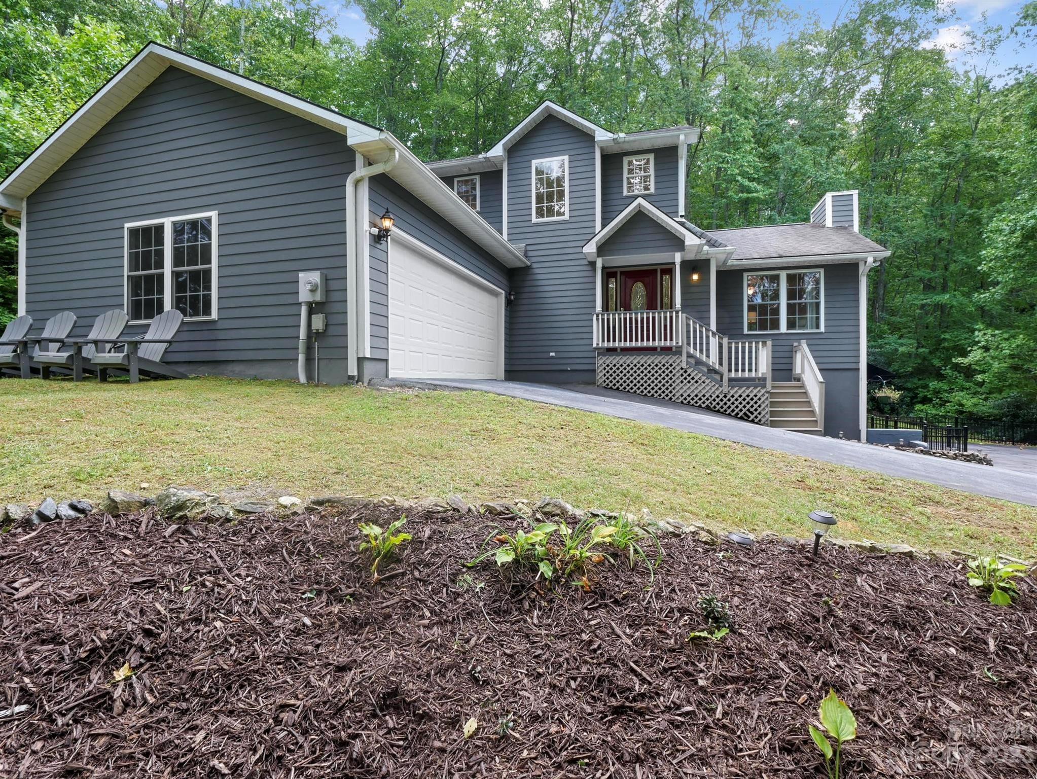 a front view of a house with a garden