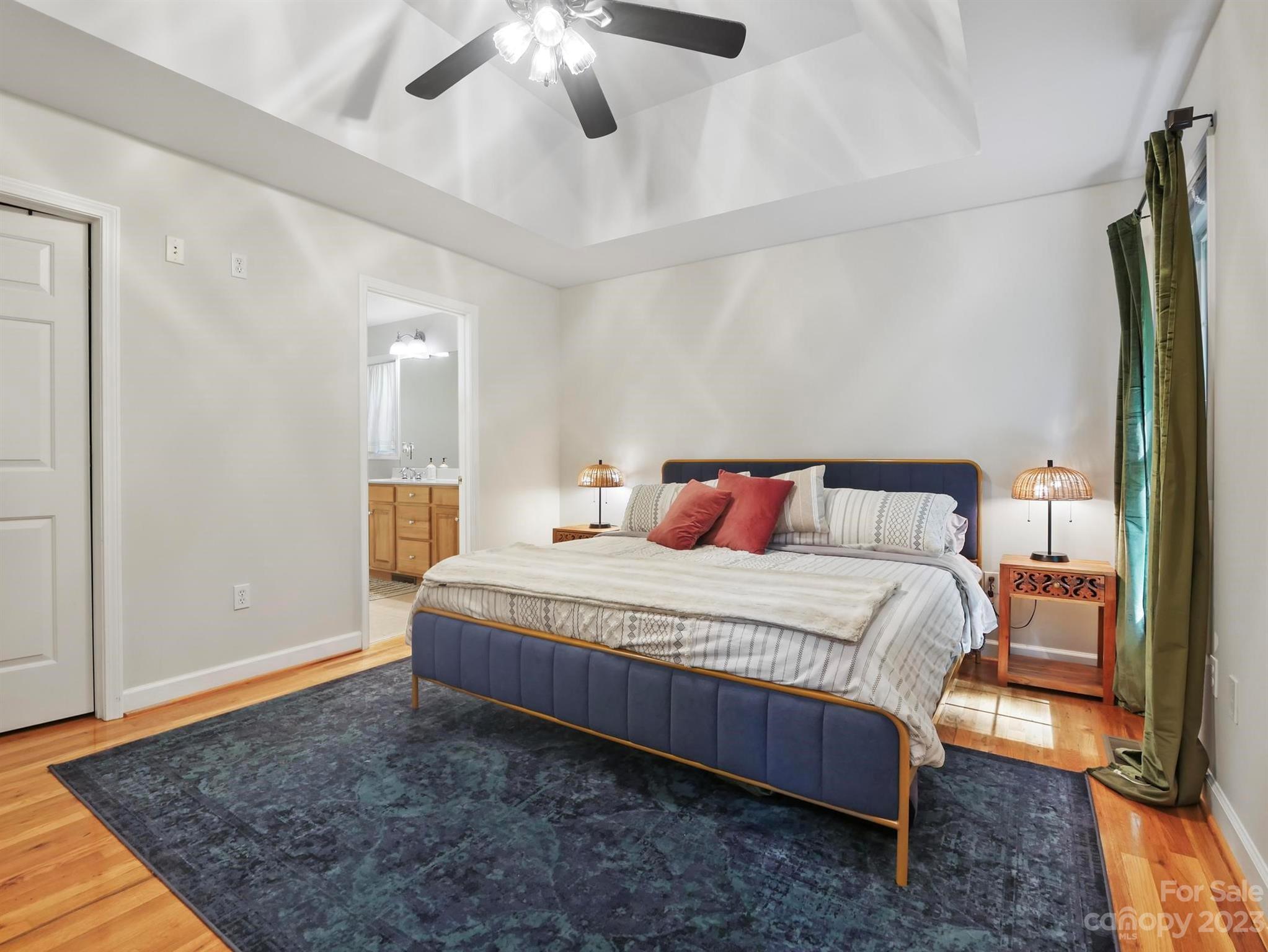 25 Falcon Crest Drive Fairview, NC 28730 - Photo 11 of 41 a bedroom with a bed rug and wooden floor