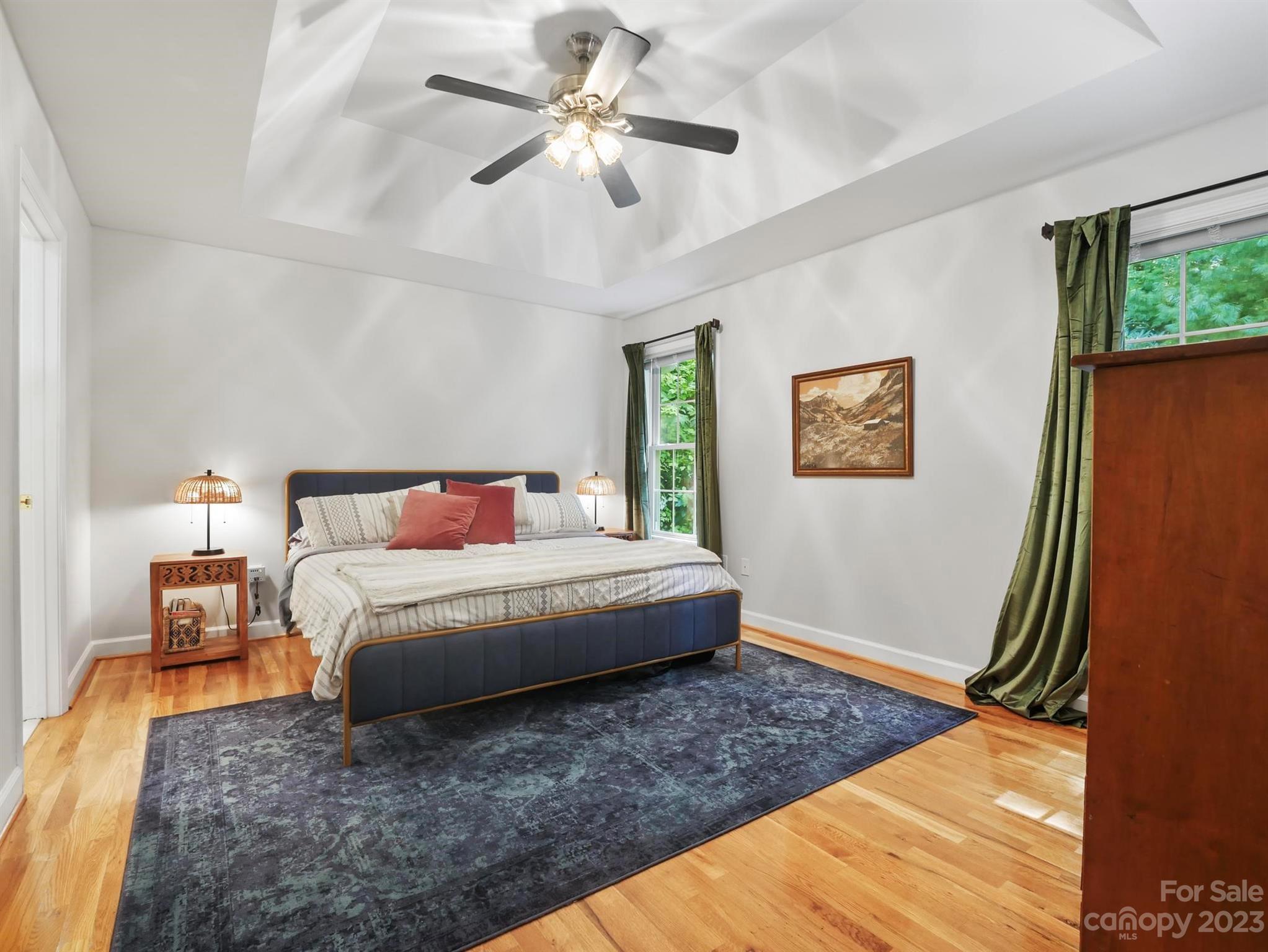 25 Falcon Crest Drive Fairview, NC 28730 - Photo 12 of 41 a spacious bedroom with a bed and a chandelier
