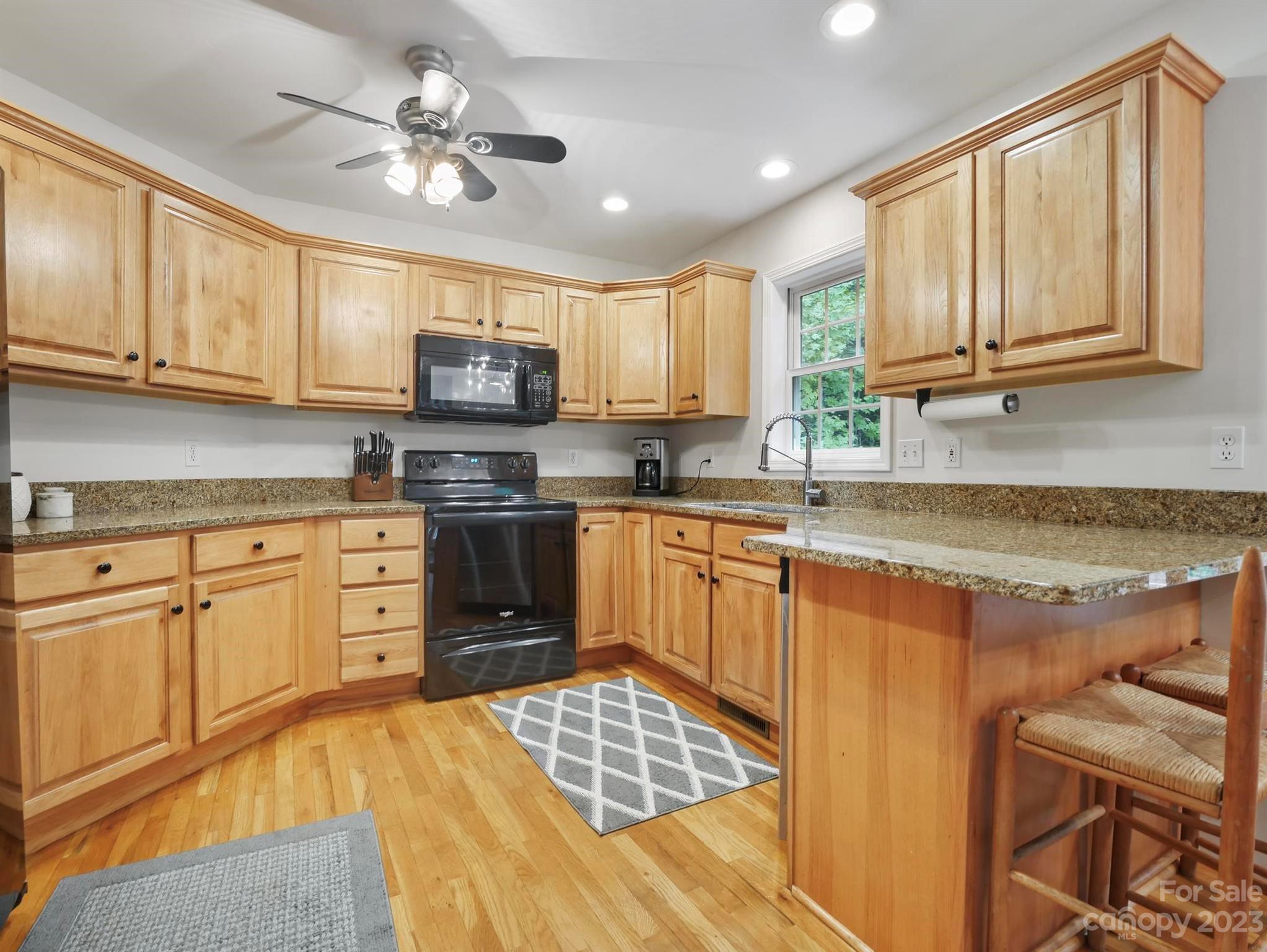 25 Falcon Crest Drive Fairview, NC 28730 - Photo 2 of 41 a kitchen with stainless steel appliances granite countertop a stove sink and cabinets