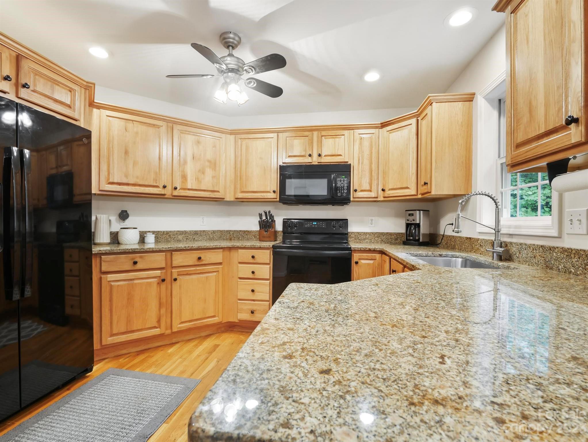 25 Falcon Crest Drive Fairview, NC 28730 - Photo 3 of 41 a kitchen with granite countertop a stove sink cabinets and refrigerator